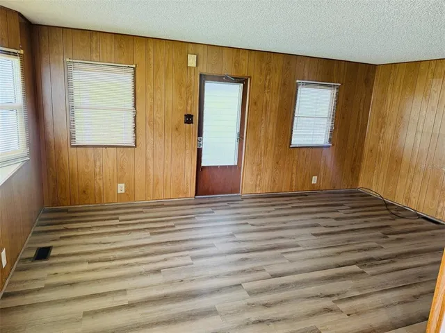 a view of a room with wooden floor and chair