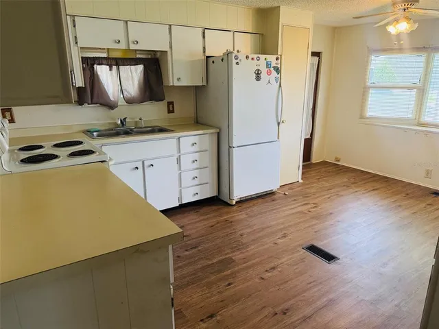 a kitchen with a stove a refrigerator and a stove