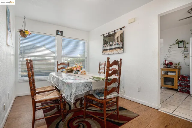 a dining room with furniture and wooden floor