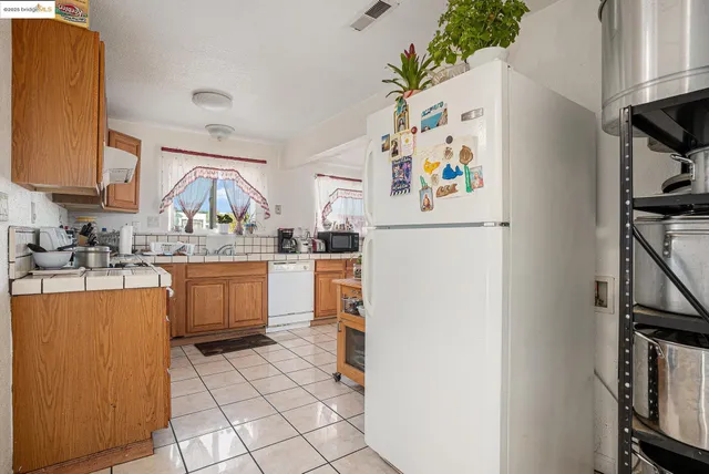 a kitchen with a refrigerator and a sink