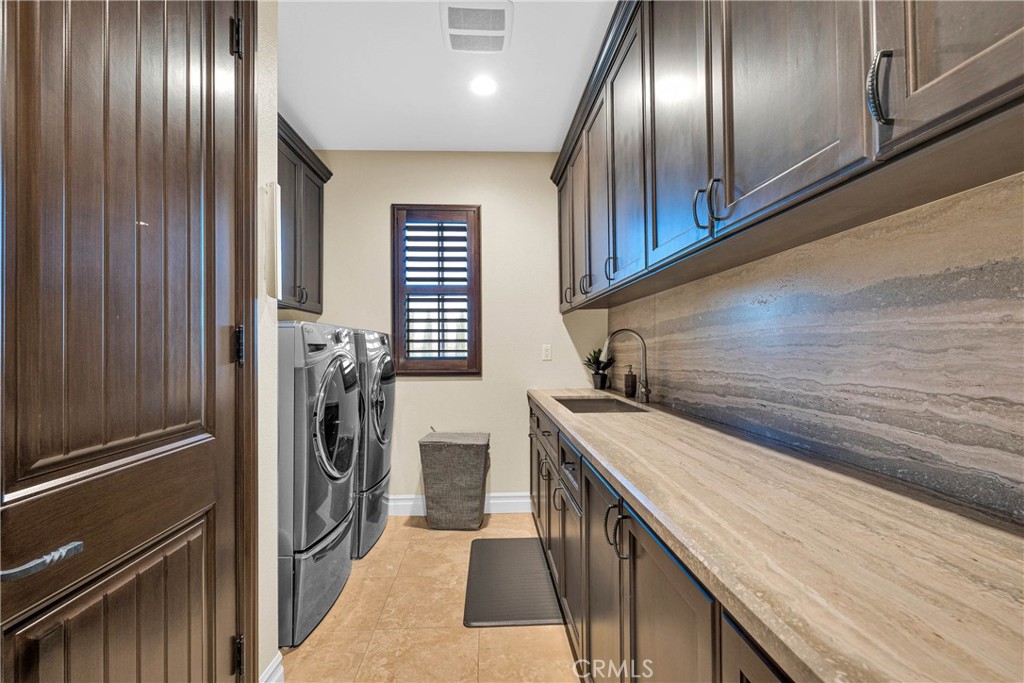 16727 Pienza Court Riverside, CA 92503 - Photo 36 of 41 Laundry finished like the rest of the home: granite counters, full cabinetry
