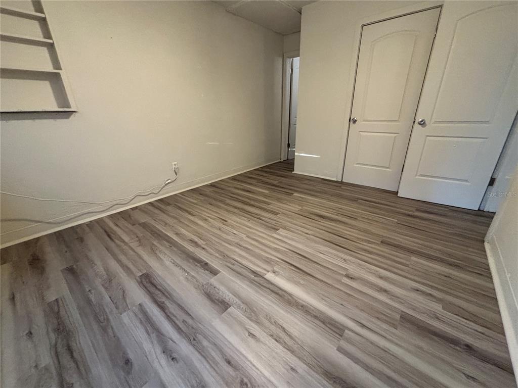 1102 Sunset Point Road, Unit 2 Clearwater, FL 33755 - Photo 11 of 17 a view of empty room with wooden floor