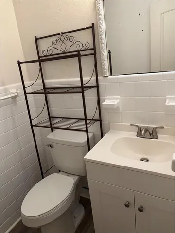 a white toilet sitting next to a bathroom sink