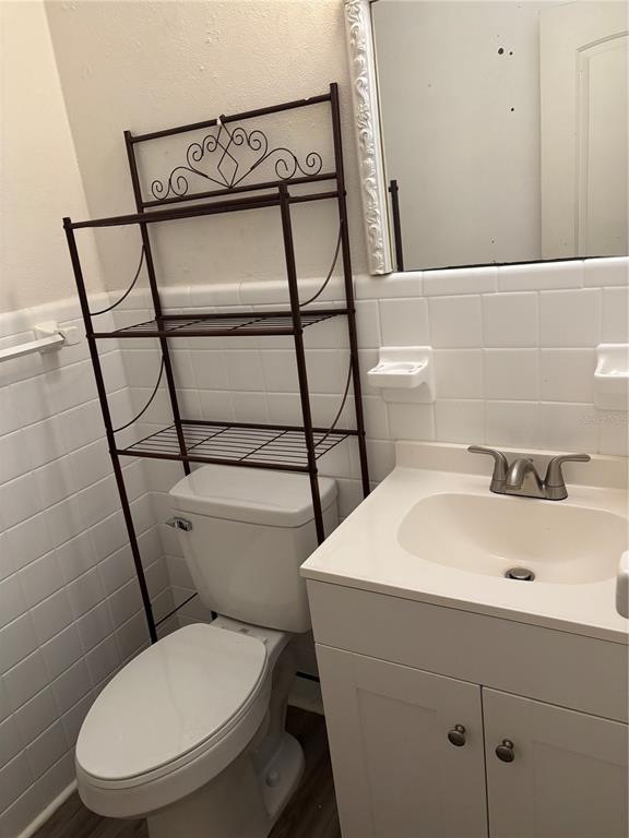 1102 Sunset Point Road, Unit 2 Clearwater, FL 33755 - Photo 14 of 17 a white toilet sitting next to a bathroom sink