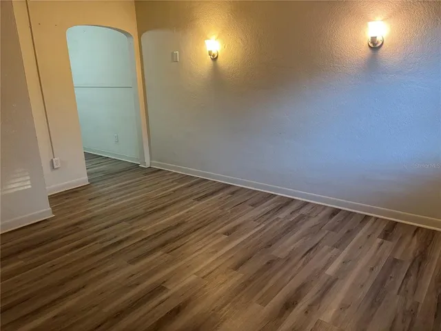 a view of a room with wooden floor and brick walls