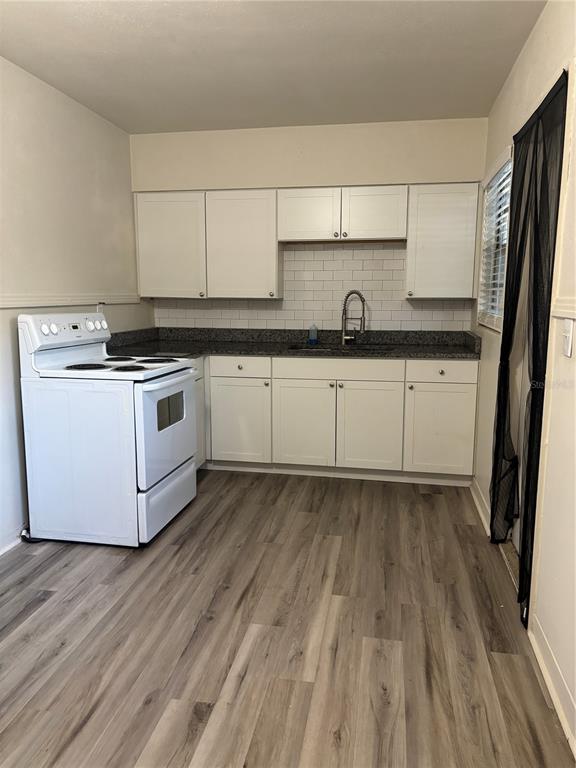 1102 Sunset Point Road, Unit 2 Clearwater, FL 33755 - Photo 6 of 17 a kitchen with a sink and wooden floor