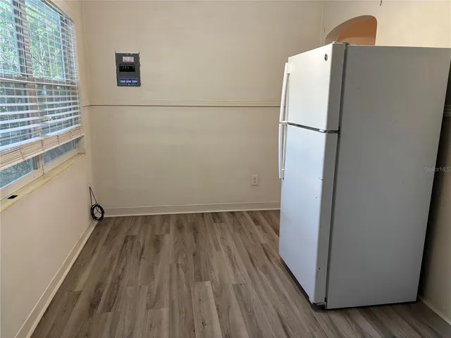 a view of a refrigerator in kitchen and wooden floor
