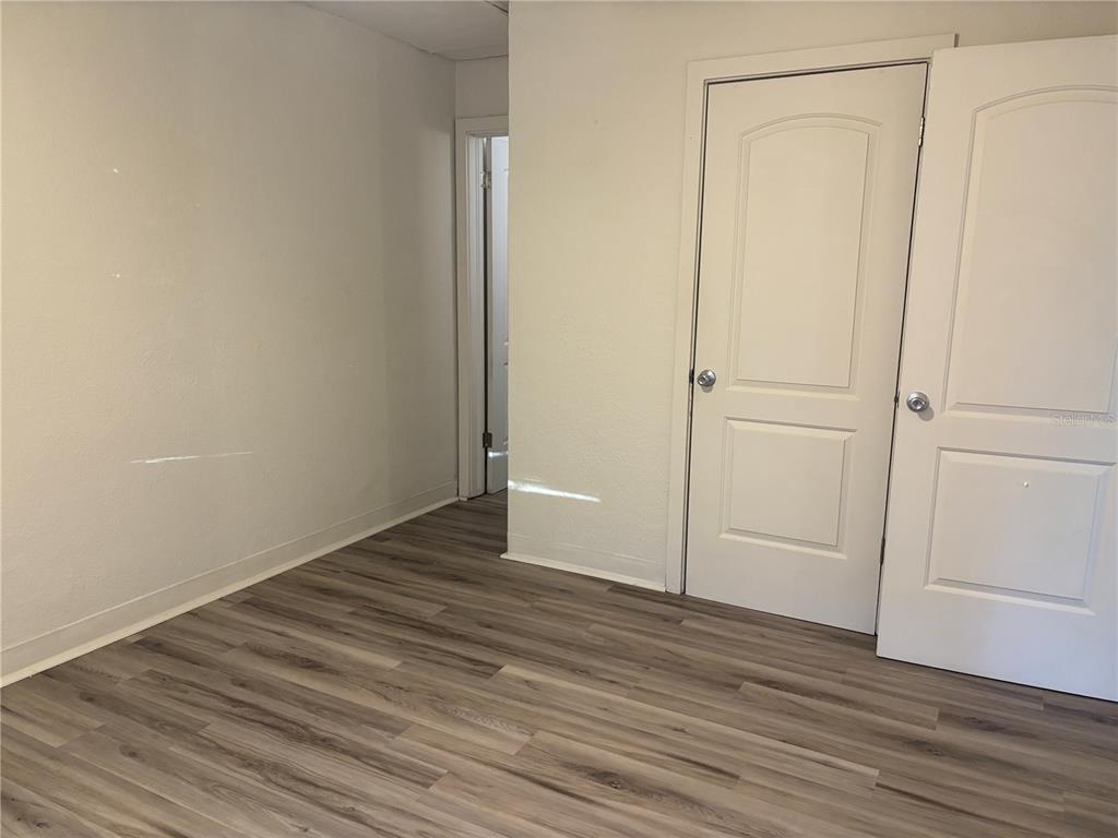 1102 Sunset Point Road, Unit 2 Clearwater, FL 33755 - Photo 10 of 17 a view of an empty room with wooden floor