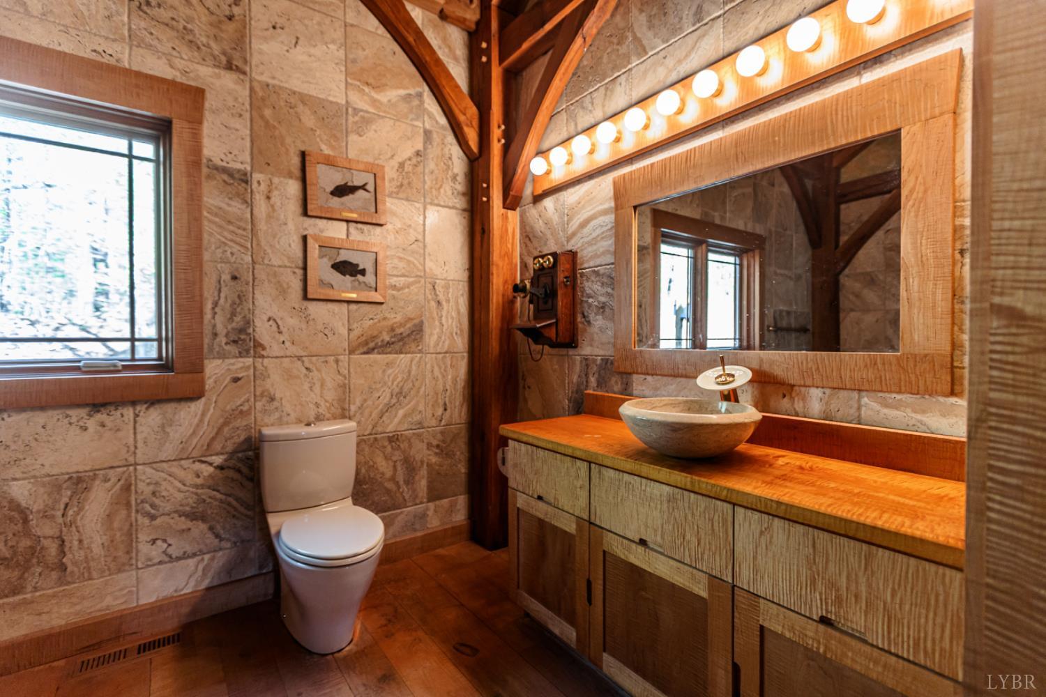 278 Salt Lick Lane Appomattox, VA 24522 - Photo 33 of 78 a bathroom with a toilet sink and mirror