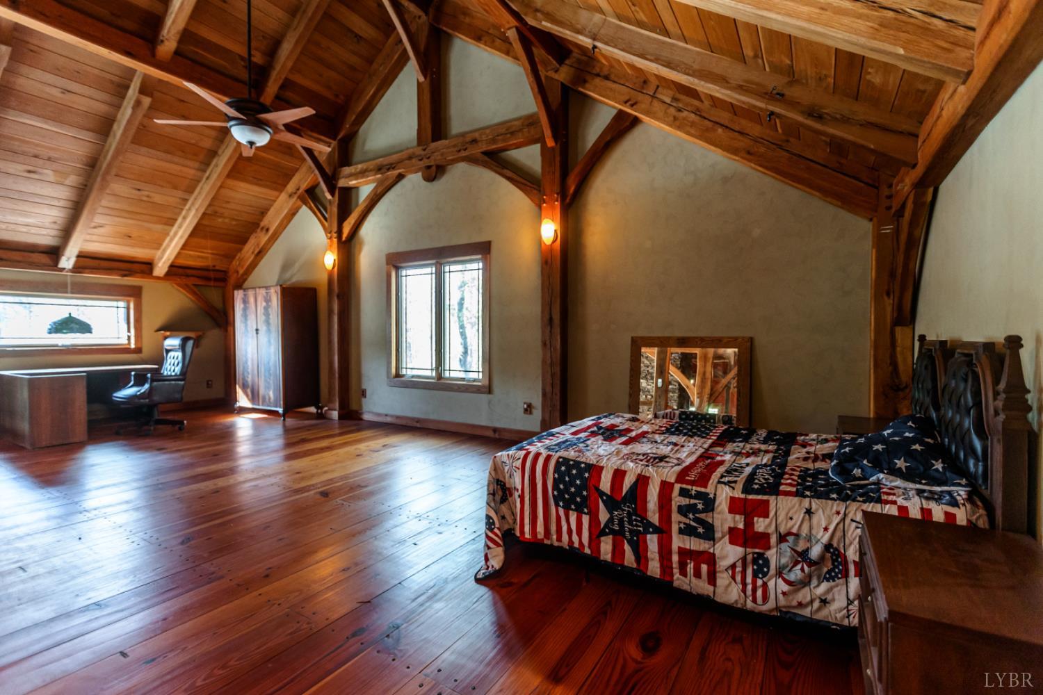 278 Salt Lick Lane Appomattox, VA 24522 - Photo 38 of 78 a bedroom with a bed next to a window with wooden floor