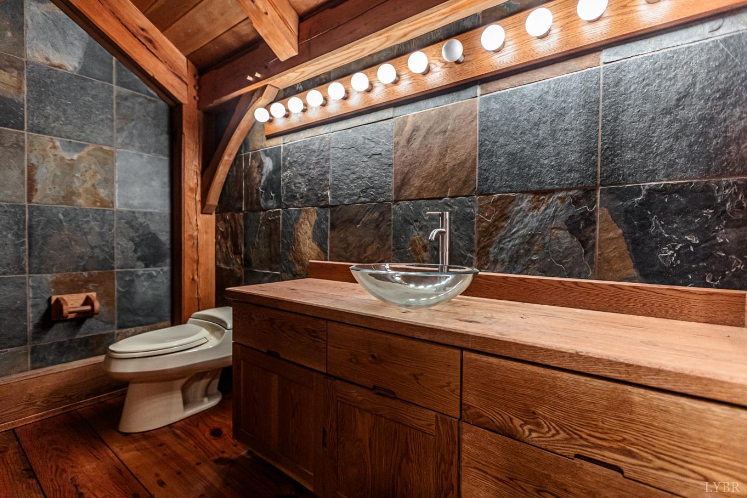 278 Salt Lick Lane Appomattox, VA 24522 - Photo 49 of 78 a bathroom with a sink a toilet and mirror