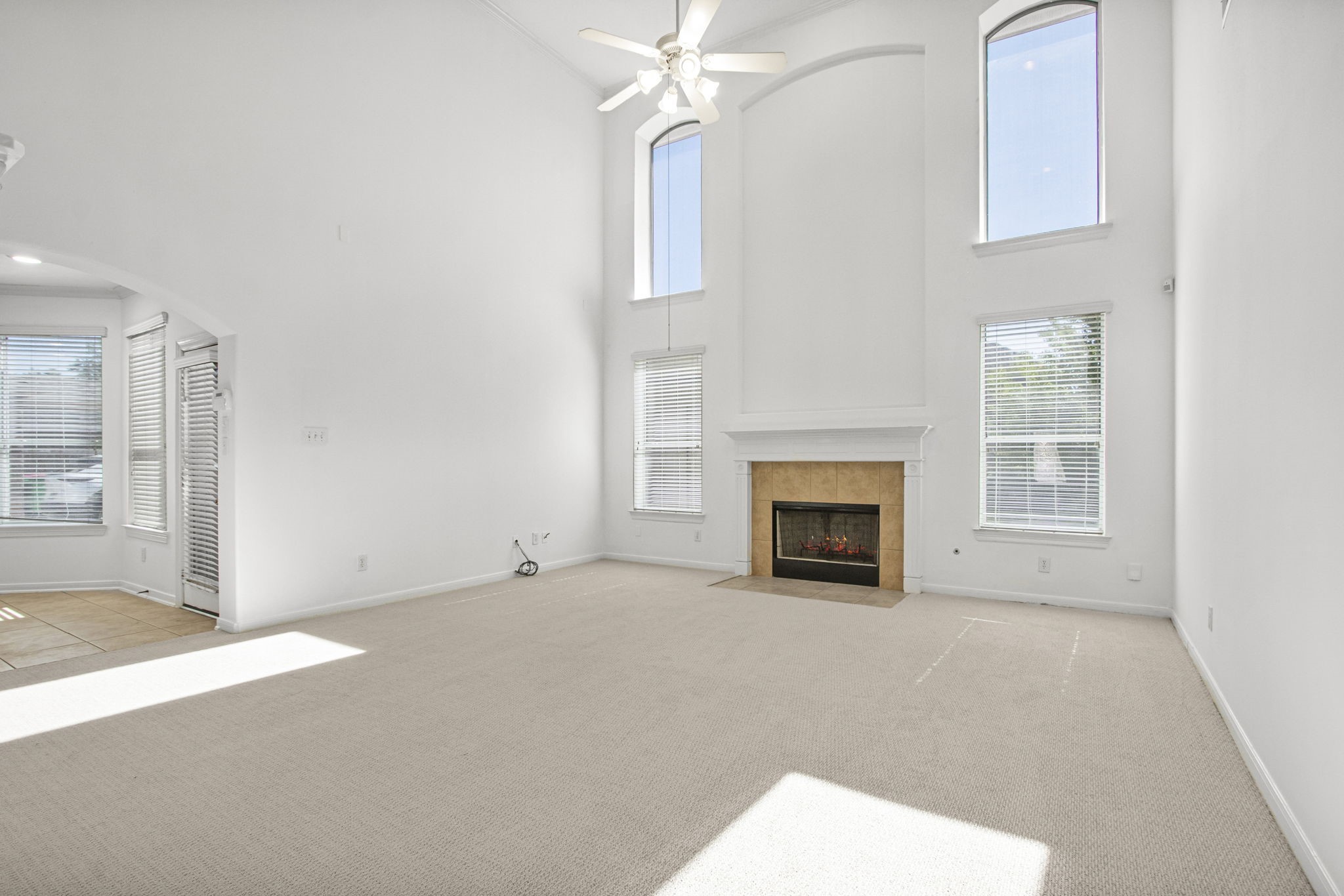 6731 Pinetop Glen Lane Spring, TX 77379 - Photo 13 of 47 an empty room with windows and fireplace