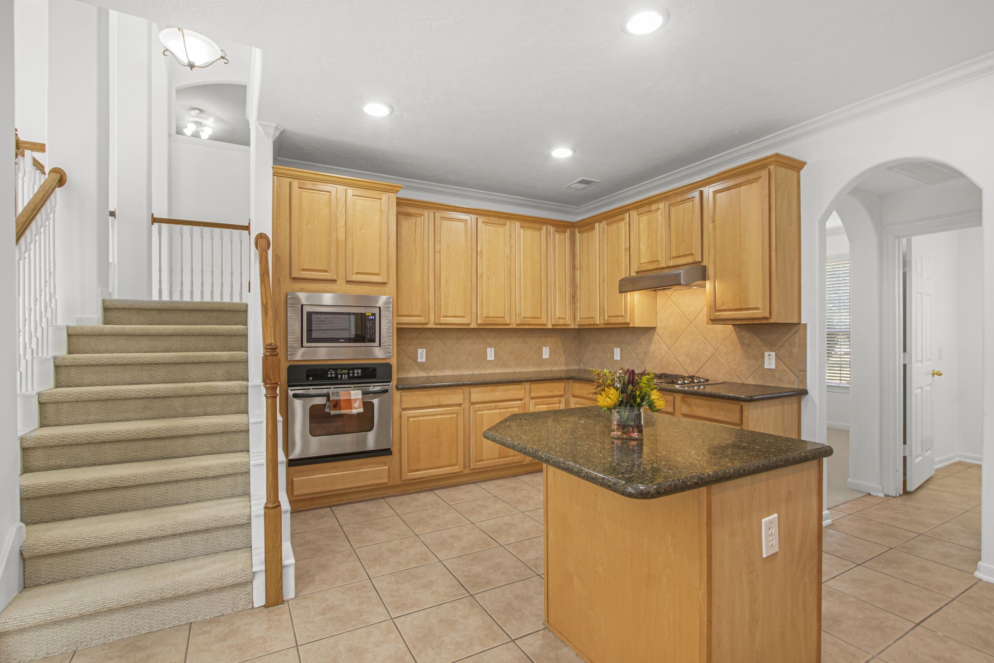 6731 Pinetop Glen Lane Spring, TX 77379 - Photo 19 of 47 a kitchen with stainless steel appliances granite countertop a sink stove and refrigerator