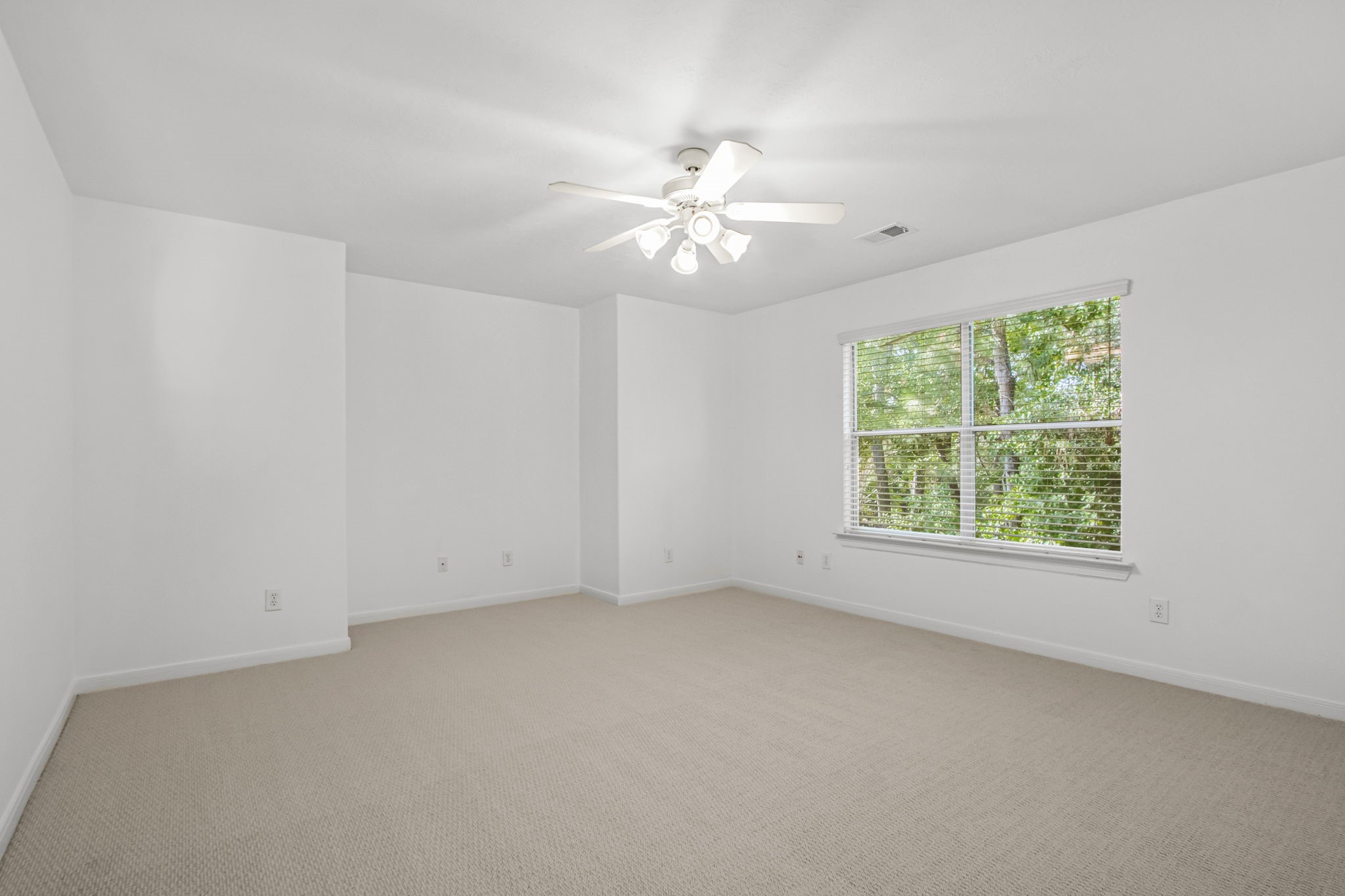 6731 Pinetop Glen Lane Spring, TX 77379 - Photo 28 of 47 an empty room with a window and a fan