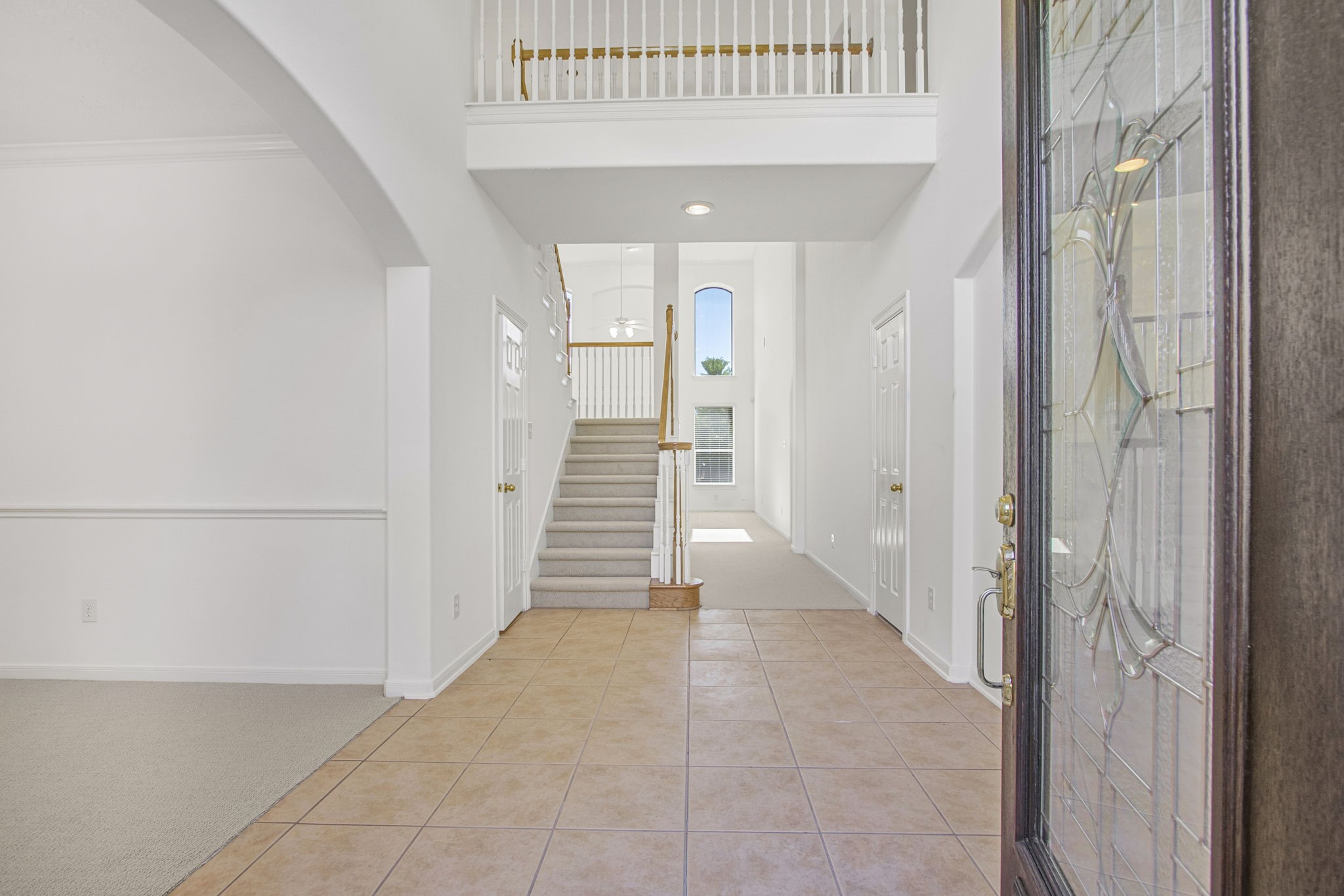 6731 Pinetop Glen Lane Spring, TX 77379 - Photo 4 of 47 a view of a hallway with wooden cabinets and staircase