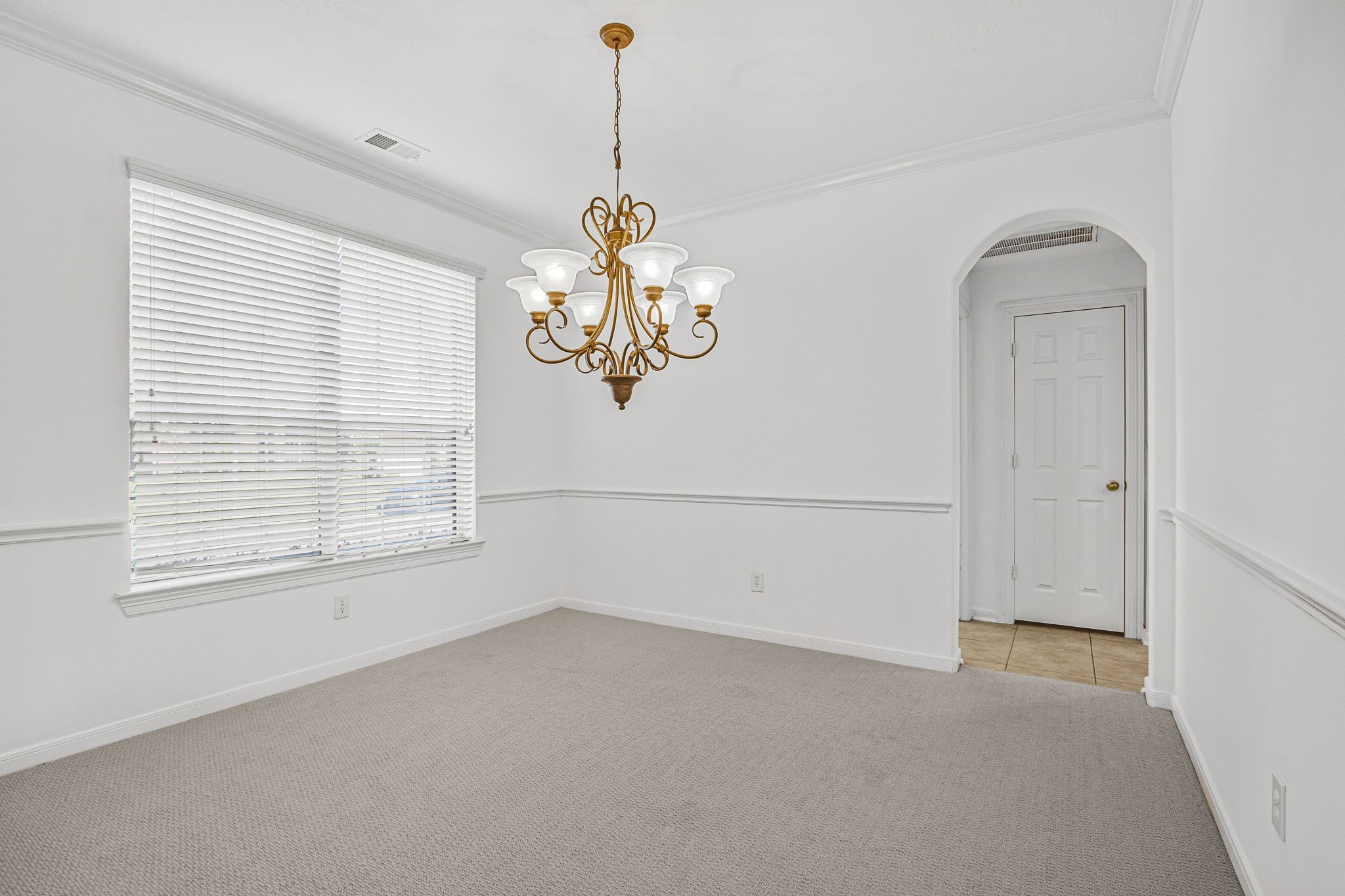 6731 Pinetop Glen Lane Spring, TX 77379 - Photo 7 of 47 an empty room with a window and a chandelier