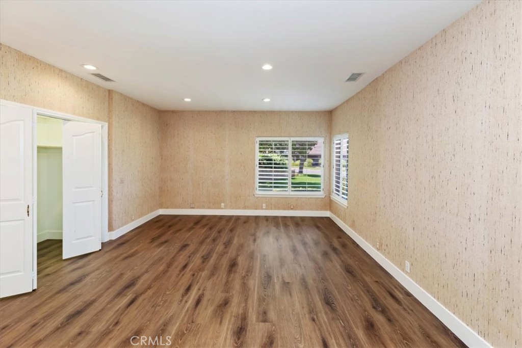 1507 Weston Way Riverside, CA 92506 - Photo 32 of 55 a view of an empty room with wooden floor and a window