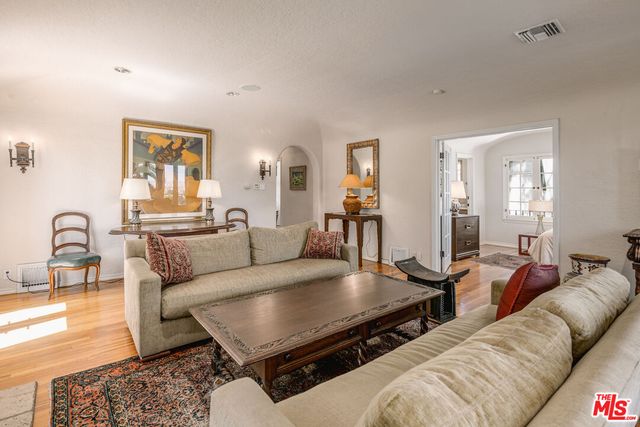 a living room with furniture and wooden floor