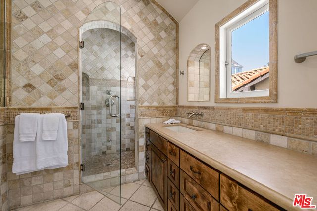 a bathroom with a sink a vanity and a mirror