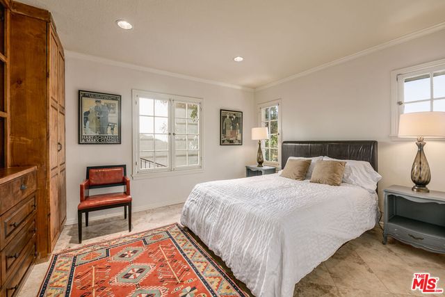 a bedroom with a bed and a lamp