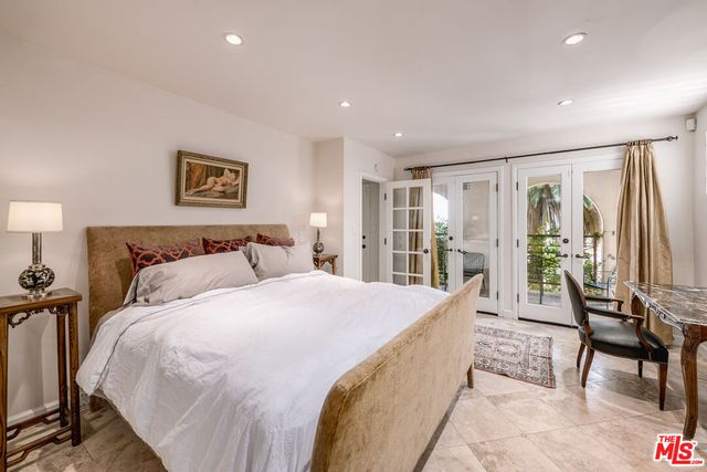 a spacious bedroom with a bed and a large window