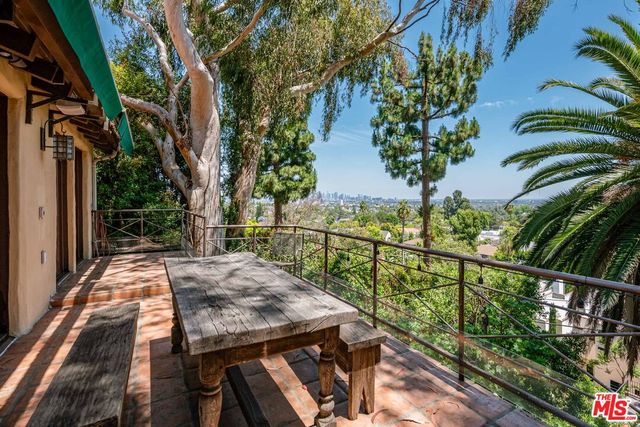 a view of a balcony with two chairs