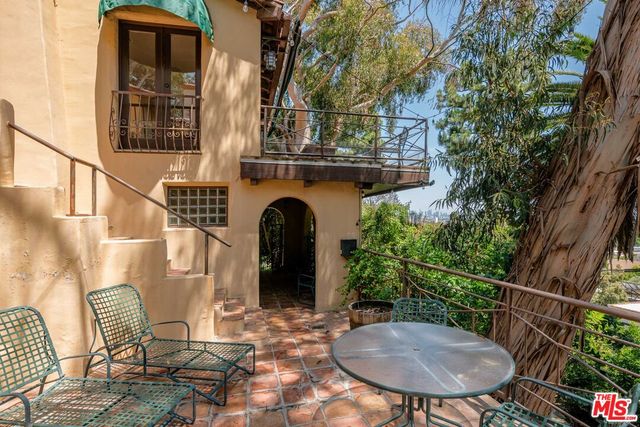 a view of a chairs and table in the balcony