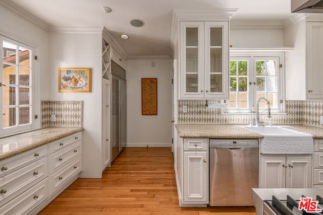 a spacious bathroom with a granite countertop sink and a mirror