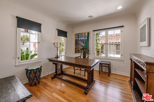 a view of a workspace with furniture and a window
