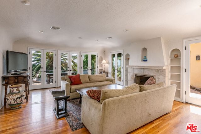 a living room with fireplace furniture and a flat screen tv
