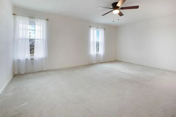 an empty room with windows and closet