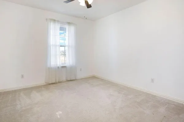 a bathroom with a window a toilet and a shower