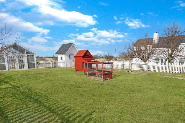 a view of a house with a backyard