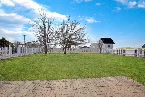 a white bath tub sitting next to a white wall