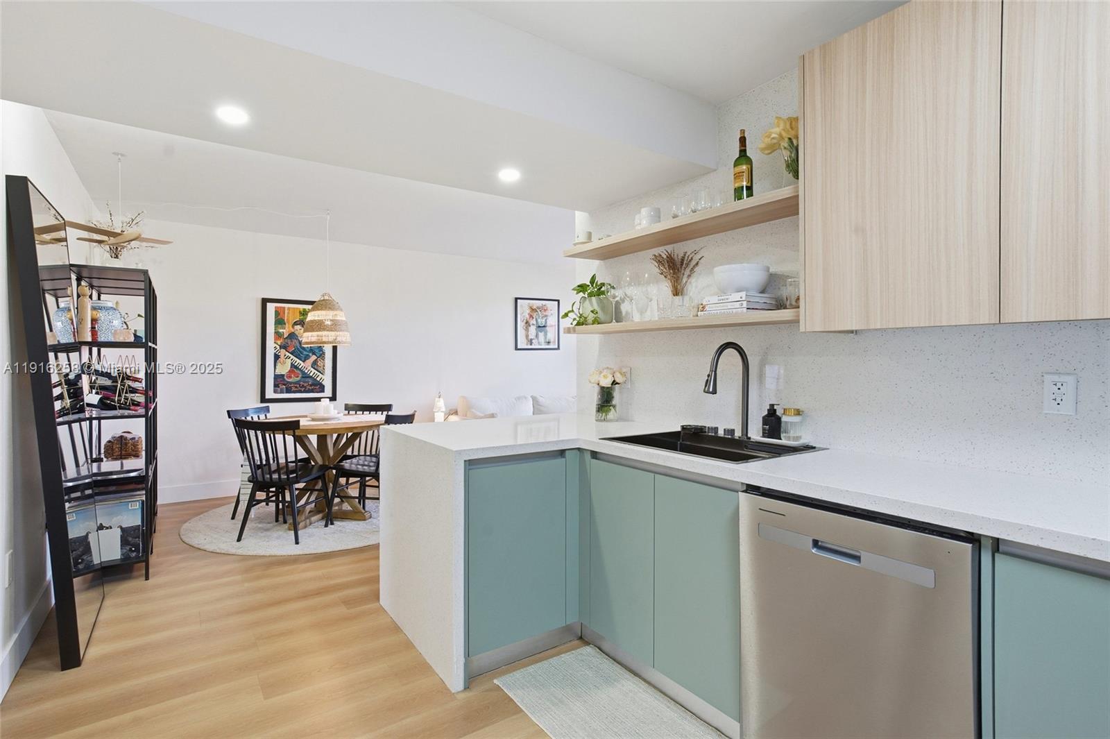 1100 11th Street, Unit 405 Miami Beach, FL 33139 - Photo 11 of 28 a kitchen with stainless steel appliances granite countertop a sink and cabinets