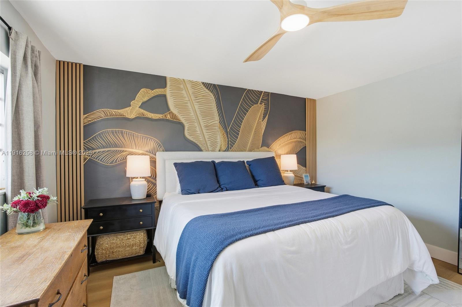 1100 11th Street, Unit 405 Miami Beach, FL 33139 - Photo 18 of 28 a bedroom with a bed and dresser with wooden floor