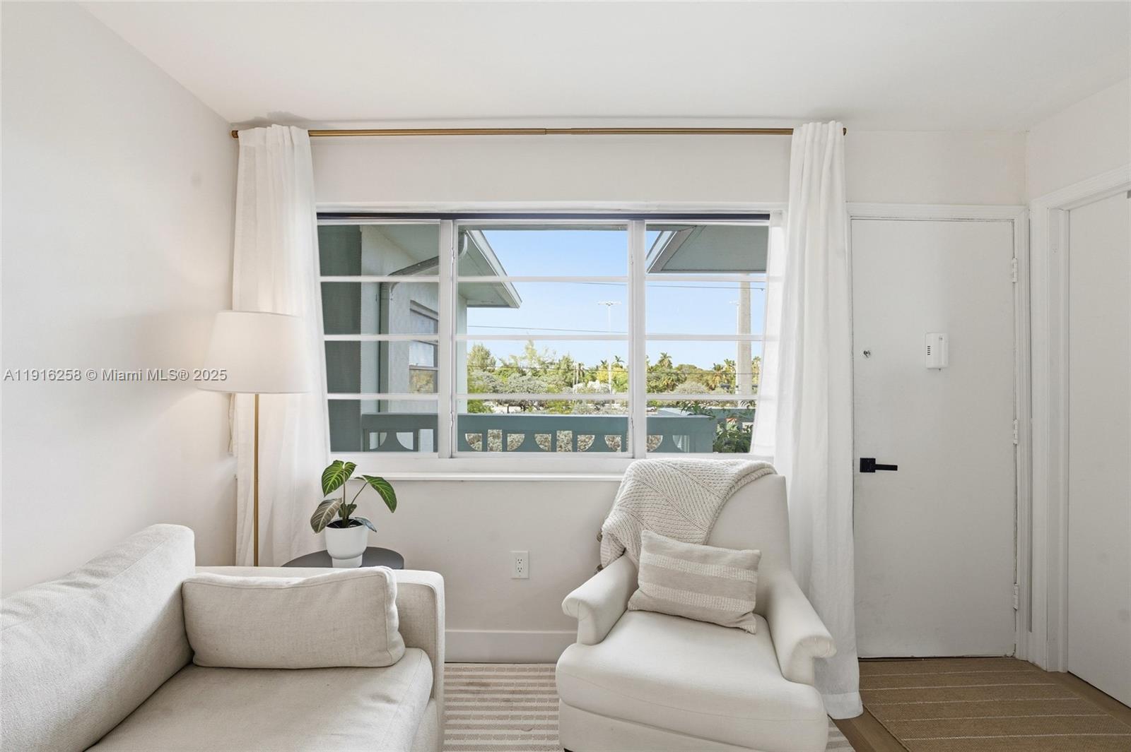 1100 11th Street, Unit 405 Miami Beach, FL 33139 - Photo 4 of 28 a living room with furniture and a large window