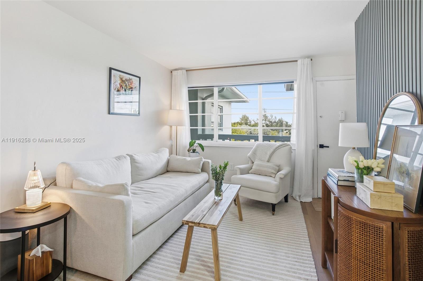 1100 11th Street, Unit 405 Miami Beach, FL 33139 - Photo 5 of 28 a living room with furniture and a large window