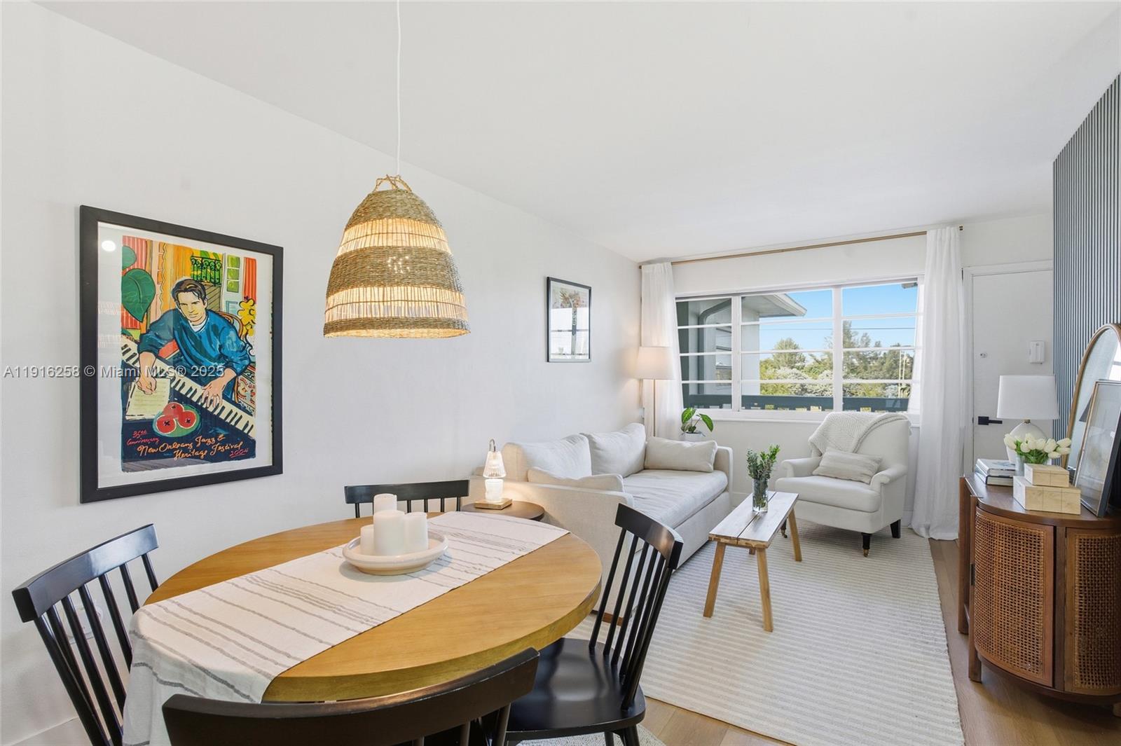 1100 11th Street, Unit 405 Miami Beach, FL 33139 - Photo 8 of 28 a view of a dining room with furniture a rug and wooden floor