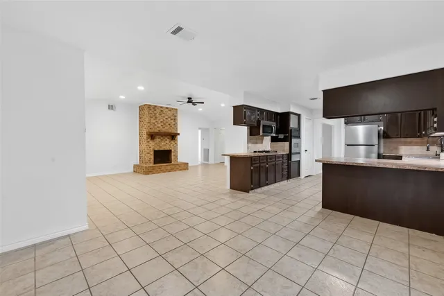 a view of an empty room with a fireplace