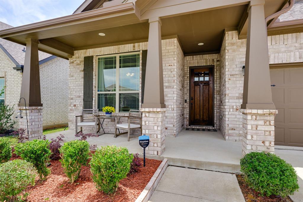 1320 Rosebush Road Aubrey, TX 76227 - Photo 4 of 33 a front view of a house with outdoor seating and plants