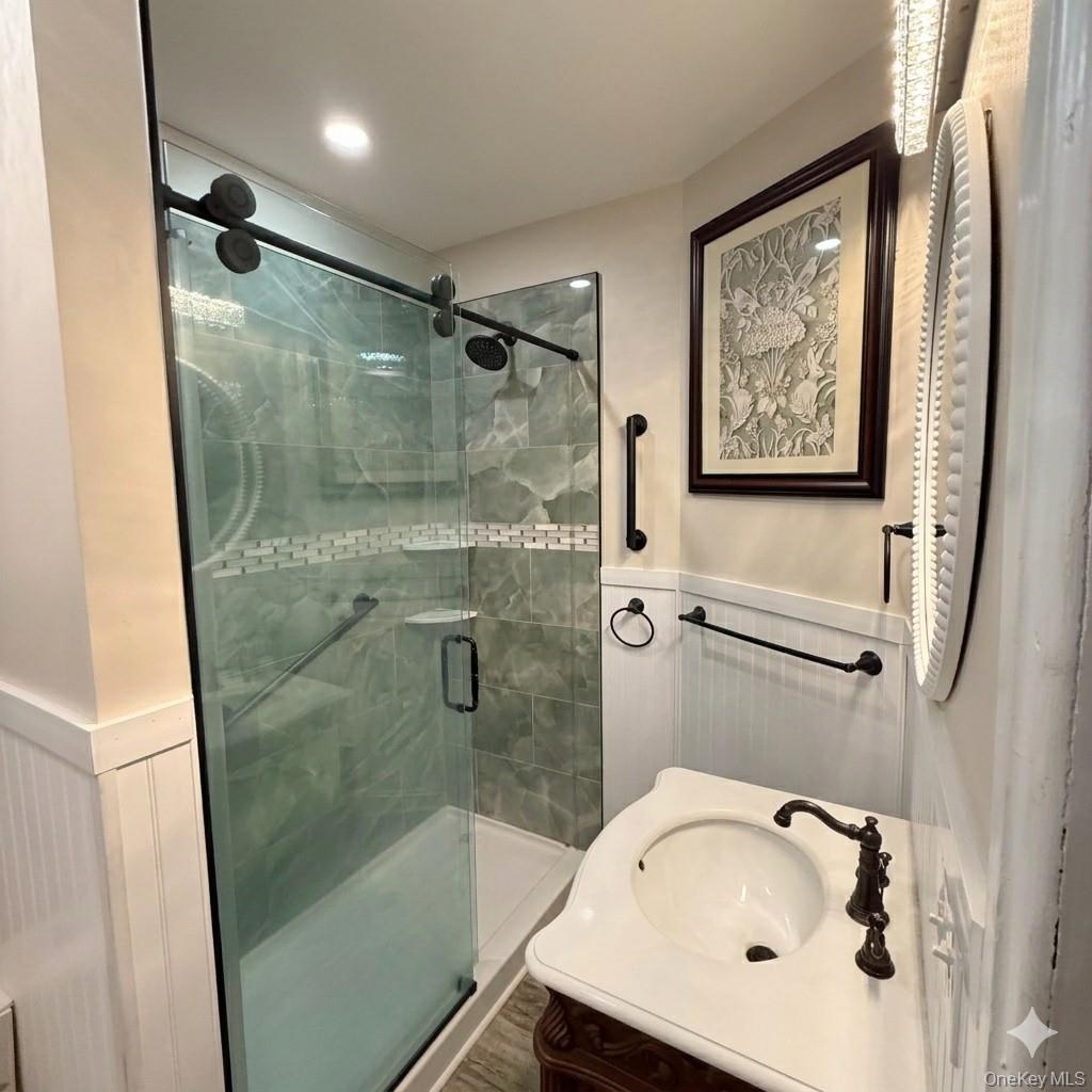 45 Maple Street Walden, NY 12586 - Photo 8 of 20 a bathroom with a tub a sink and glass door shower