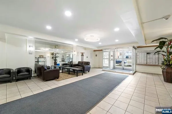 a living room with furniture and a chandelier