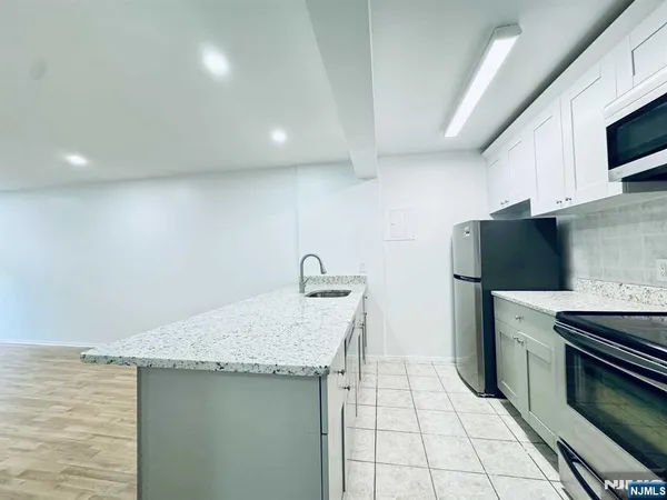 a kitchen with a sink cabinets and stainless steel appliances