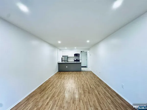 a view of a kitchen with wooden floor
