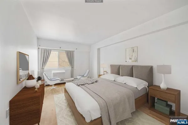 a bedroom with a bed window and a mirror