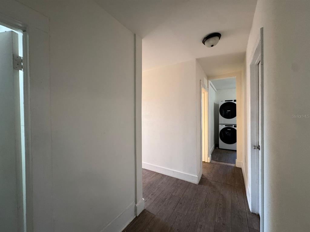4201 Cepeda Street Orlando, FL 32811 - Photo 11 of 17 a view of a hallway with wooden floor and closet