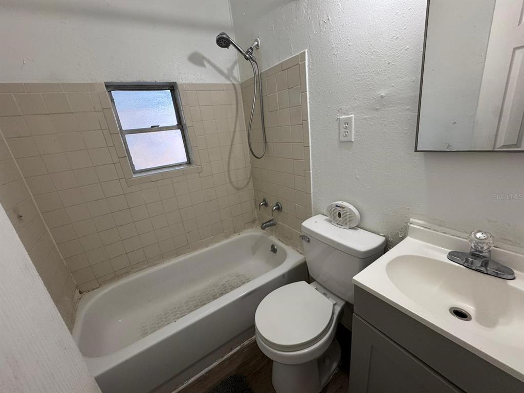 4201 Cepeda Street Orlando, FL 32811 - Photo 12 of 17 a bathroom with a sink toilet and shower
