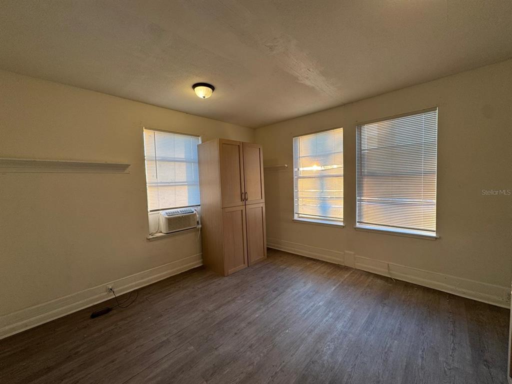4201 Cepeda Street Orlando, FL 32811 - Photo 13 of 17 a view of an empty room with wooden floor and a window