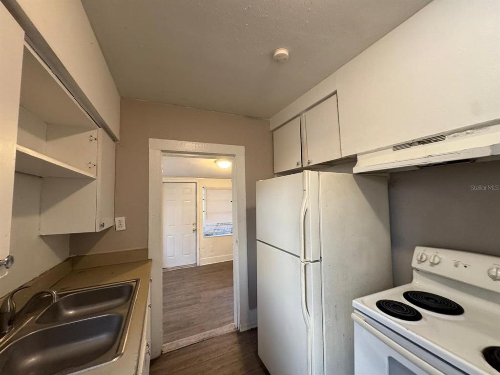 4201 Cepeda Street Orlando, FL 32811 - Photo 14 of 17 a white refrigerator freezer and a stove sitting inside of a kitchen